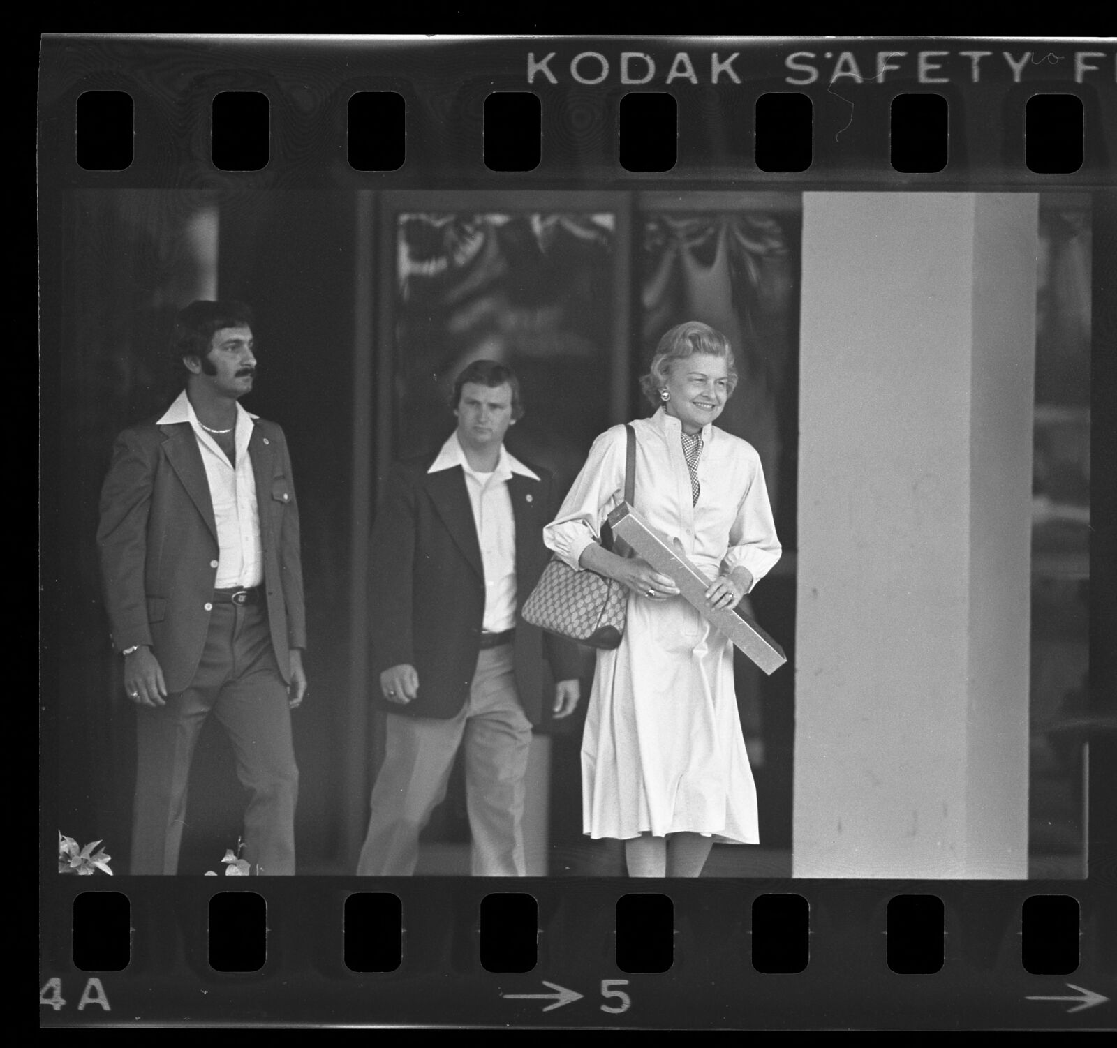 Former First Lady Betty Ford, smiling, leaving Long Beach Naval Hospital in 1978, in a raw press negative with film-edge markings.