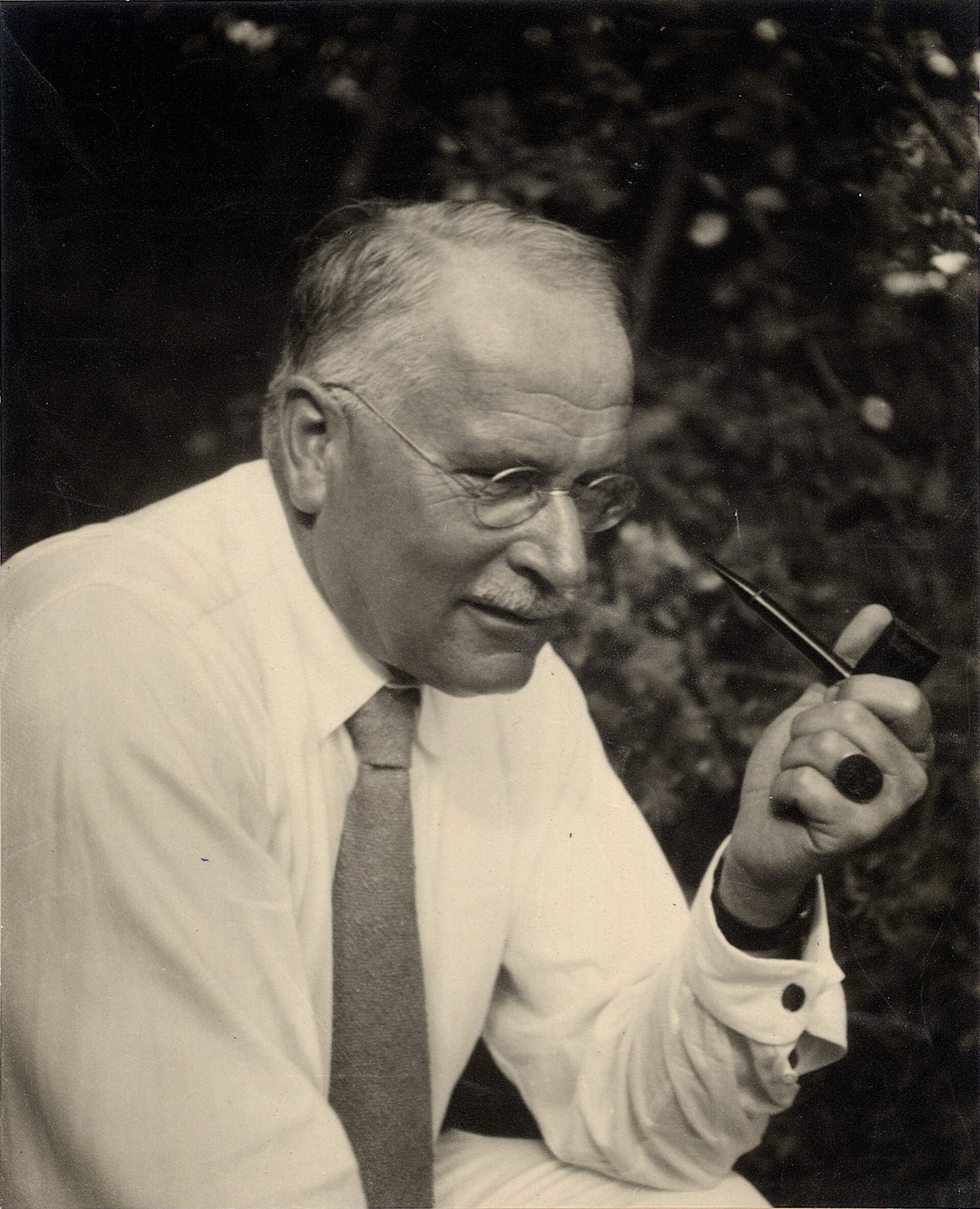A 1935 portrait of Carl Jung, holding a pipe.