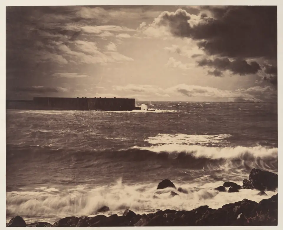 The Great Wave, Sete, 1857: a dramatic albumen seascape of waves breaking over rocks beneath a luminous clouded sky.