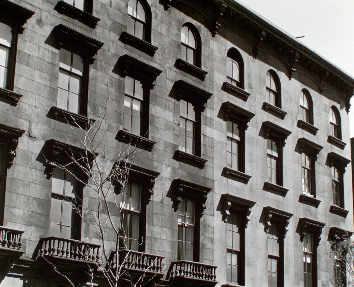 A row of nineteenth-century Brooklyn Heights brownstone facades photographed in 1936.