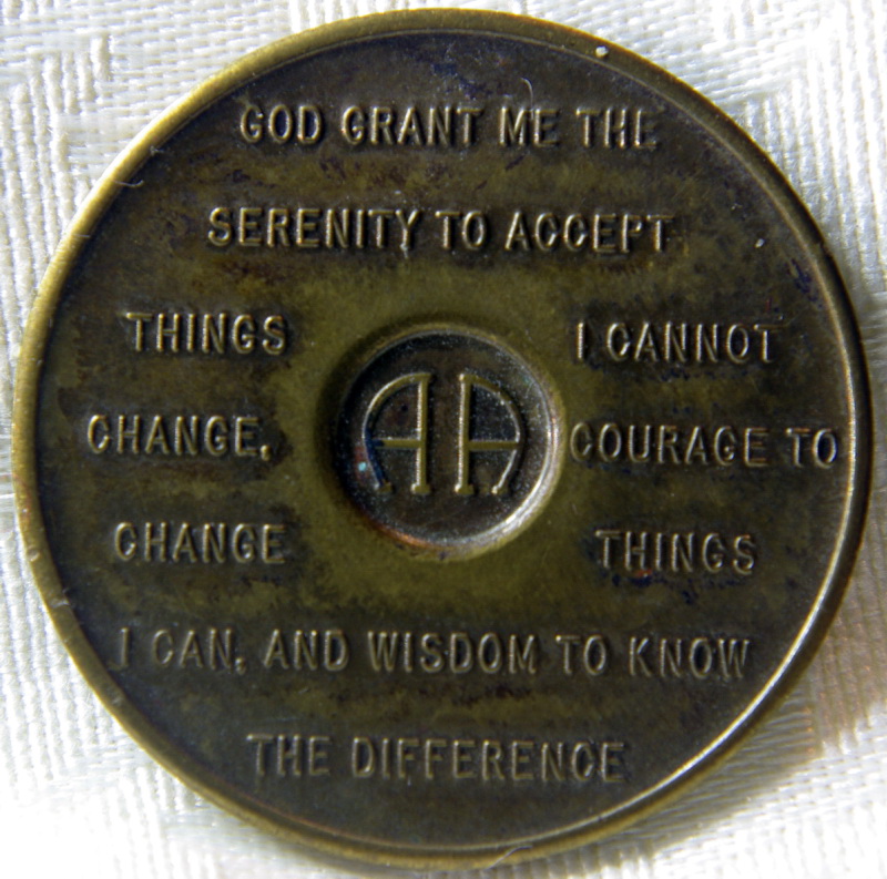 A bronze sobriety medallion, close up.