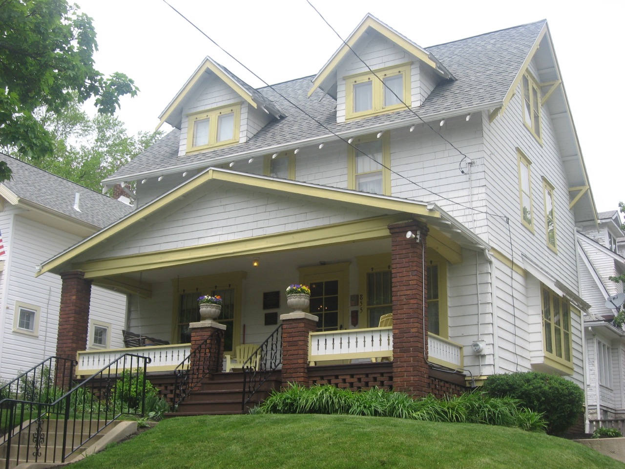 The white clapboard front of Dr. Bob's House, a two-story home on a residential street in Akron, Ohio.