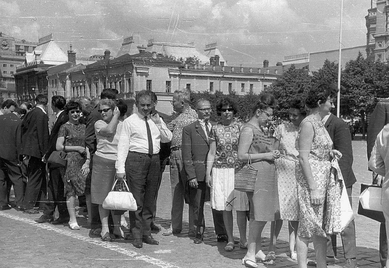 A long line of people waiting in a public square to enter Lenin's Mausoleum in Moscow.