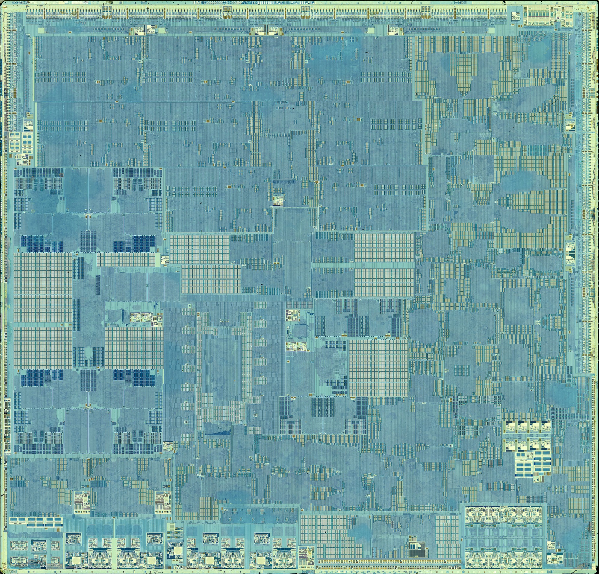 A top-down scan of the whole Apple M1 processor die in cyan and gold, its functional blocks laid out like a city map.