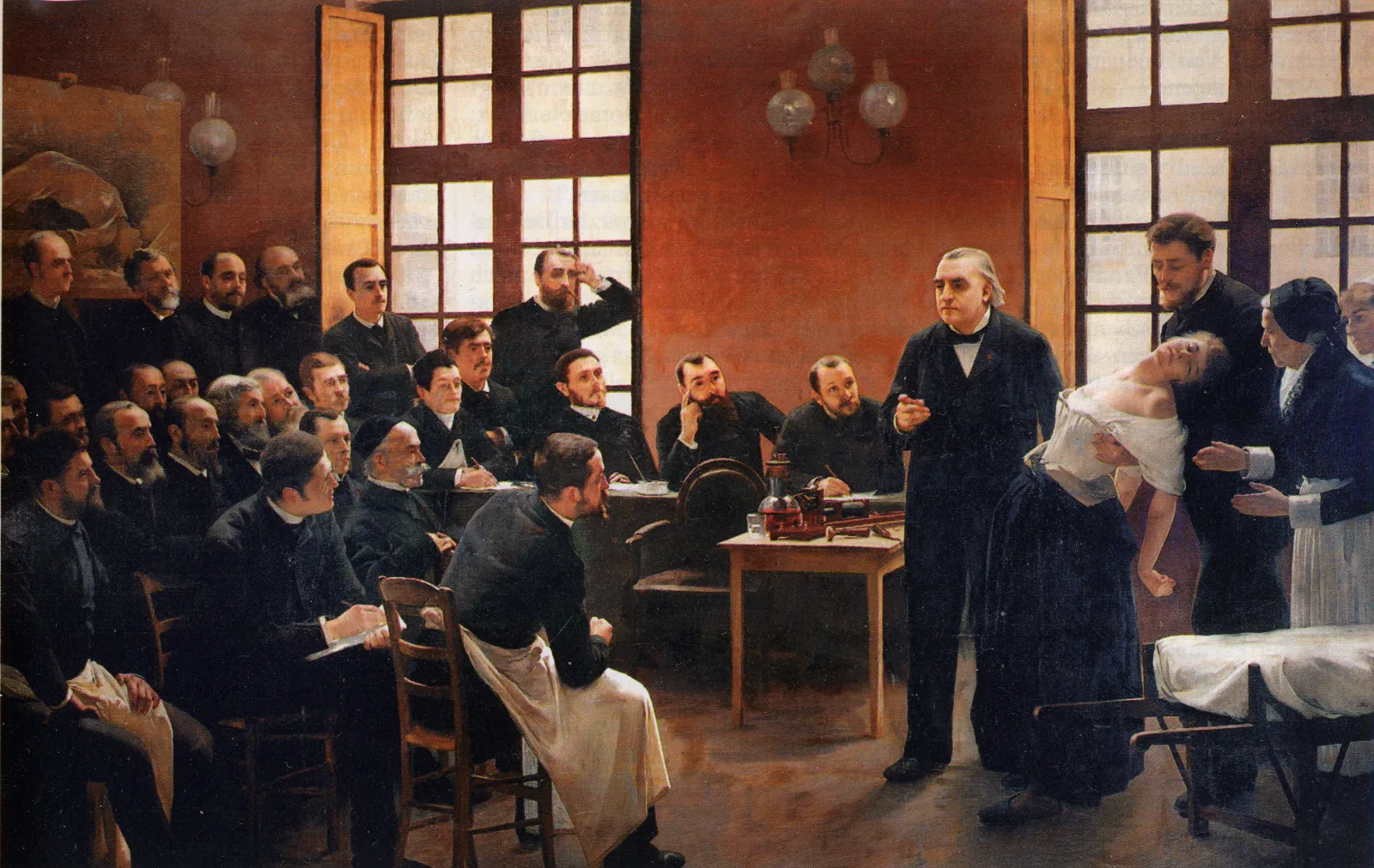 A 19th-century painting of the neurologist Jean-Martin Charcot presenting a fainting woman to a room of attentive male physicians at the Salpetriere hospital in Paris.