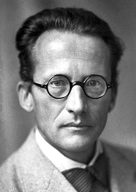 Black-and-white portrait of Erwin Schrodinger in 1933, wearing round glasses and a bow tie.
