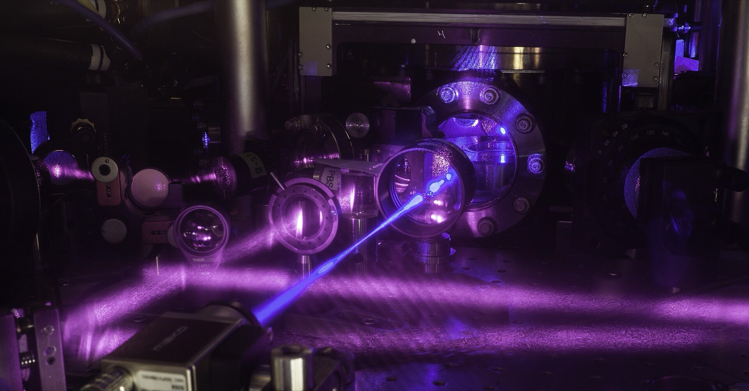 A JILA strontium optical-lattice atomic clock: an intricate optical table criss-crossed by blue laser beams, mirrors and lenses.
