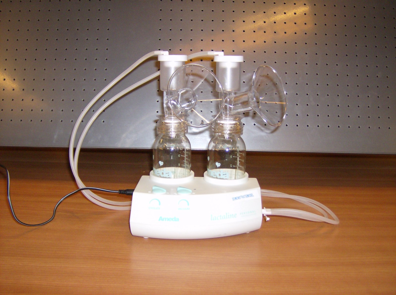 An electric breast pump shown as a single object.