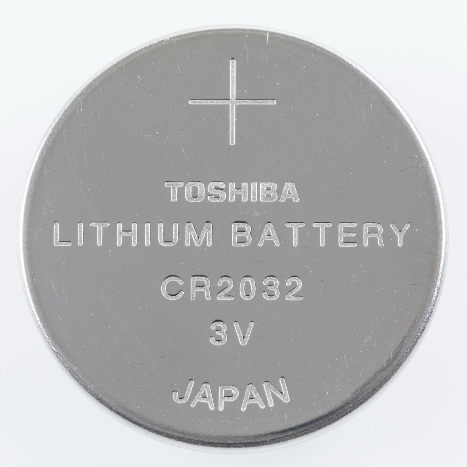 A 3-volt CR2032 lithium coin cell, the kind of button battery that is dangerous if swallowed.
