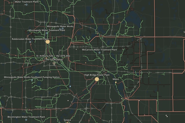 A dark map of the Twin Cities with real sewer interceptors, transmission lines, and treatment plants drawn in color.