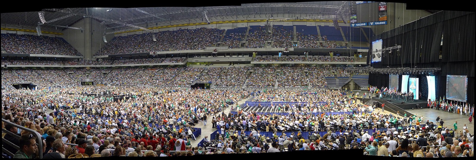 A vast arena floor and stands packed with tens of thousands of people at an AA international convention in the Alamodome.