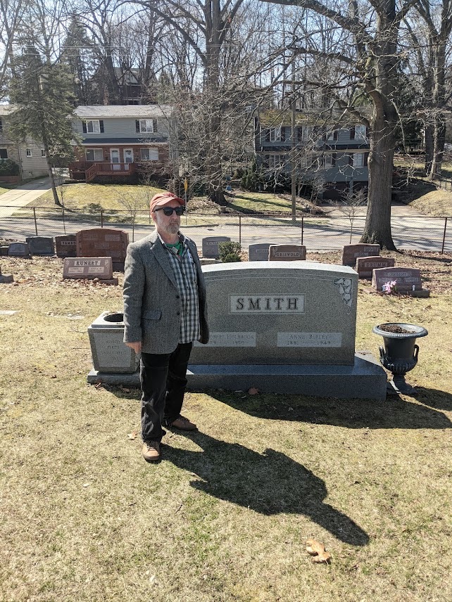 The plain granite gravestone of Robert and Anne Smith at Mount Peace Cemetery in Akron, with small tokens left on it.