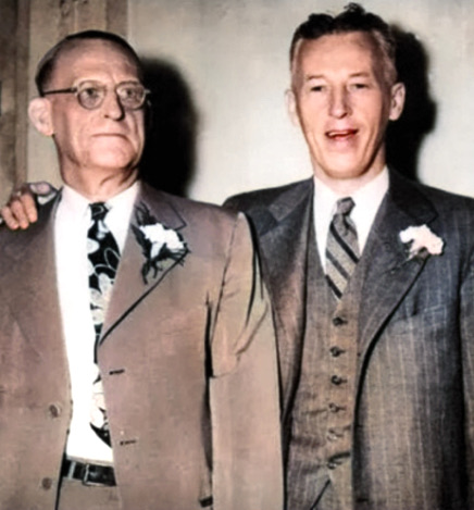 Dr. Bob Smith, older and bespectacled, standing beside a taller, younger Bill Wilson, both in suits.