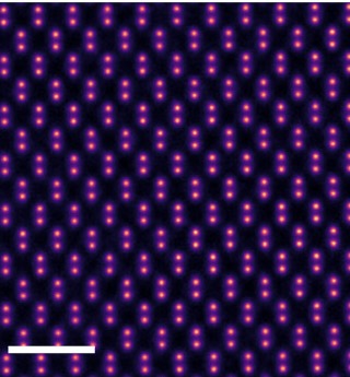 A false-color electron-microscope image resolving individual silicon atoms as a regular lattice of magenta dots.