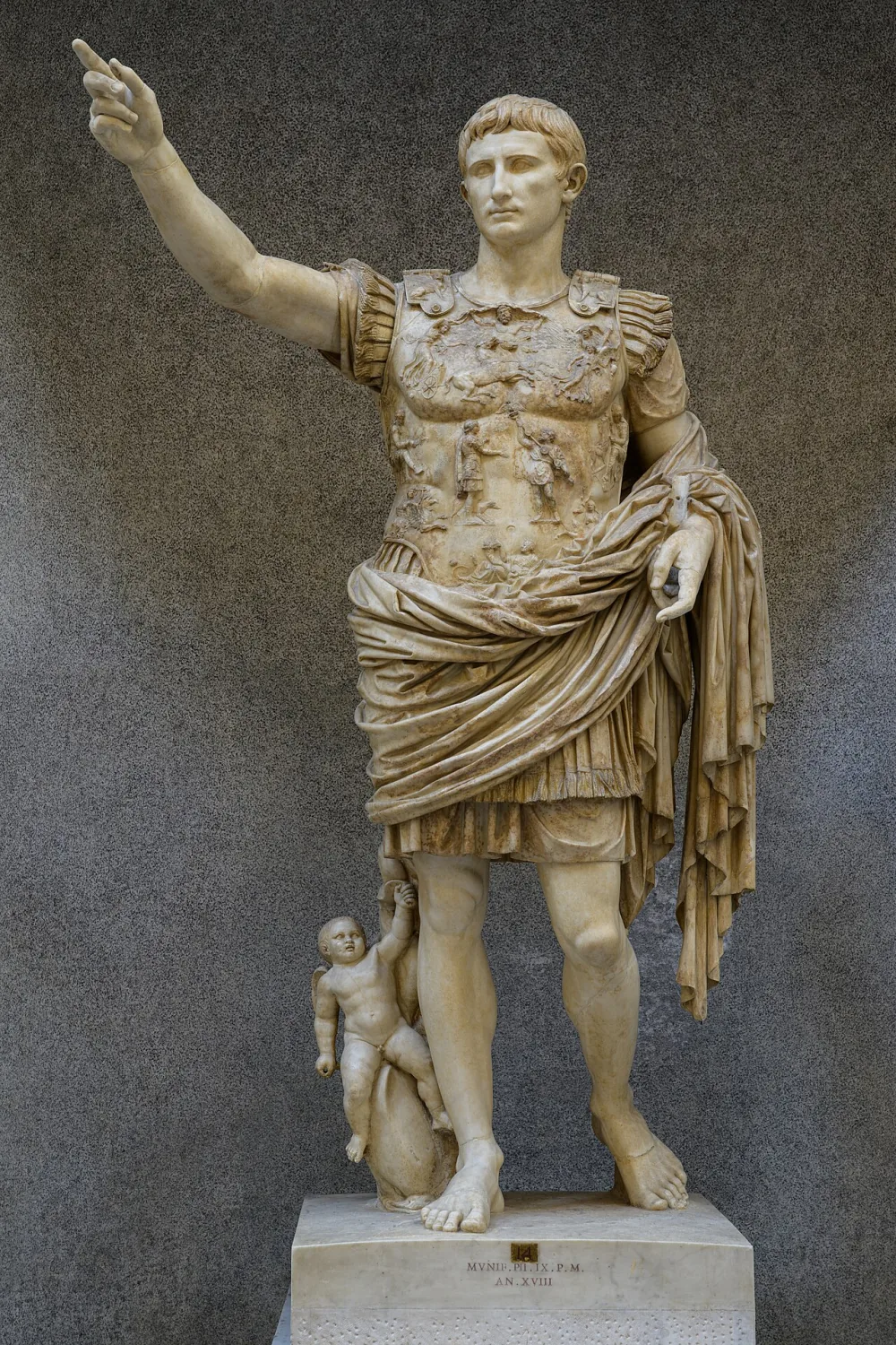 The Augustus of Prima Porta, a marble statue of the emperor in an ornately decorated muscle cuirass, one arm raised, standing in a balanced contrapposto pose.