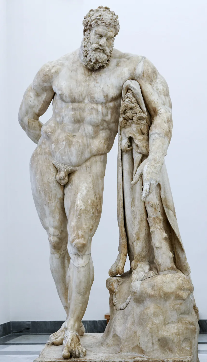 The Farnese Hercules, a colossal ancient marble statue of a heavily muscled bearded man resting on his club.