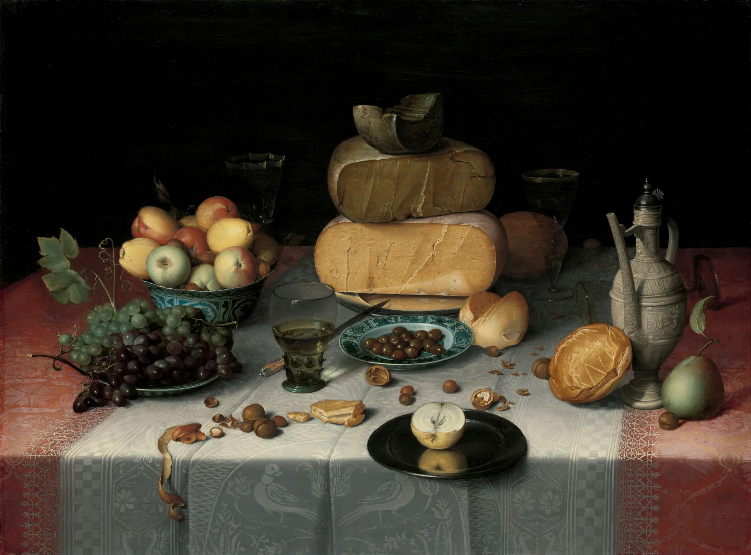 Floris van Dijck's around-1615 still life of a laid table: stacked rounds of cheese, bread, apples, grapes and nuts on a white damask cloth.