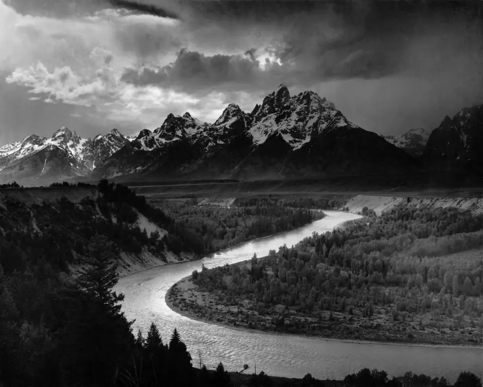 The Tetons and the Snake River, 1942: the river curving in silver S-bends toward jagged peaks under storm light.