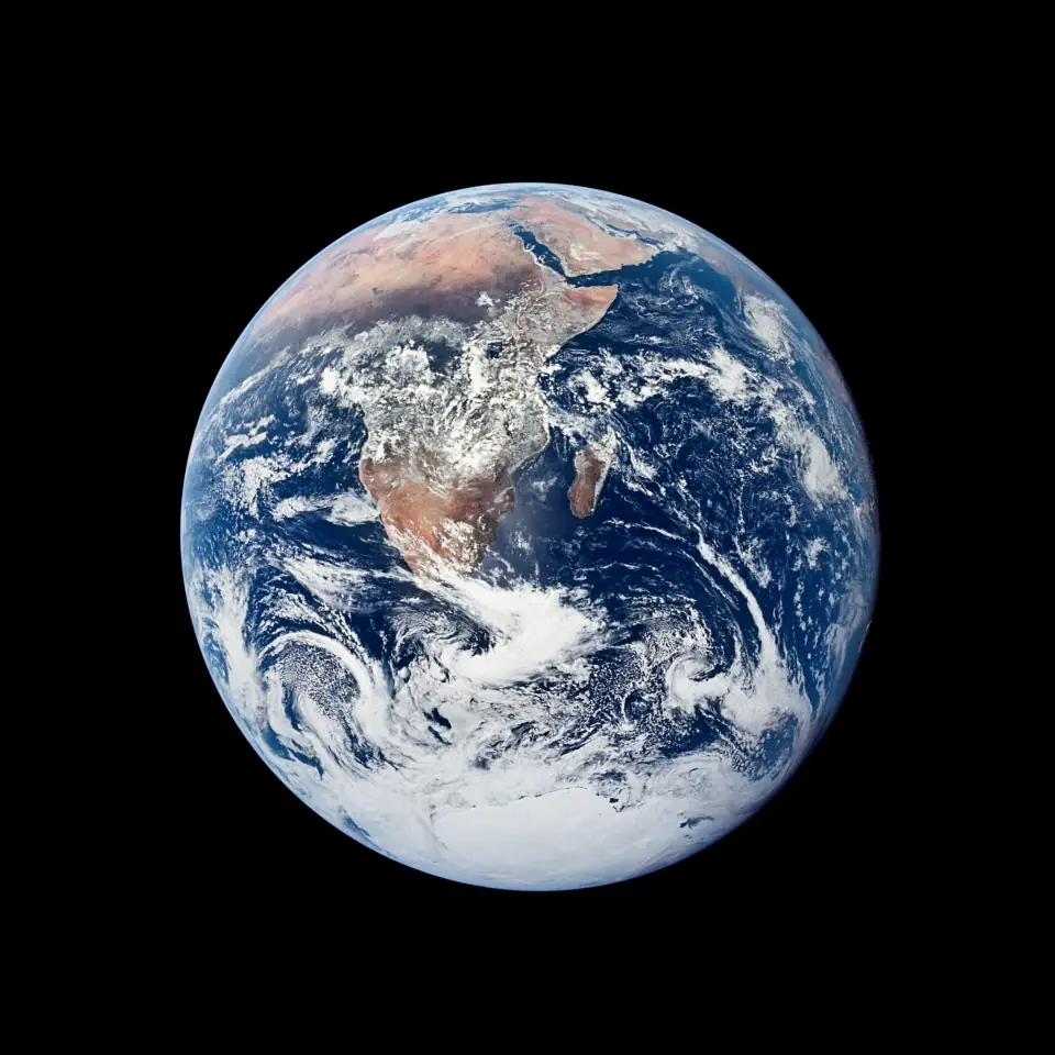 The Blue Marble: the full sunlit disk of Earth showing Africa, Arabia and Antarctica against black space.