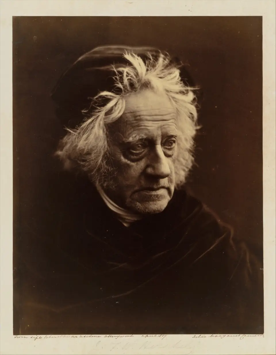 Julia Margaret Cameron's 1867 portrait of John Herschel: the astronomer's deeply lined face emerging from darkness under a halo of wild white hair.