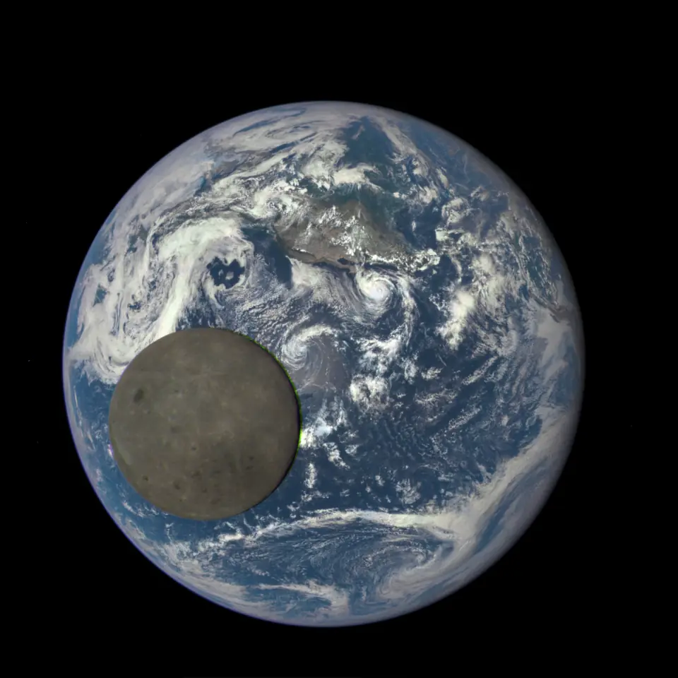 The far side of the Moon, fully lit, crossing in front of the blue sunlit Earth, photographed from a million miles away.