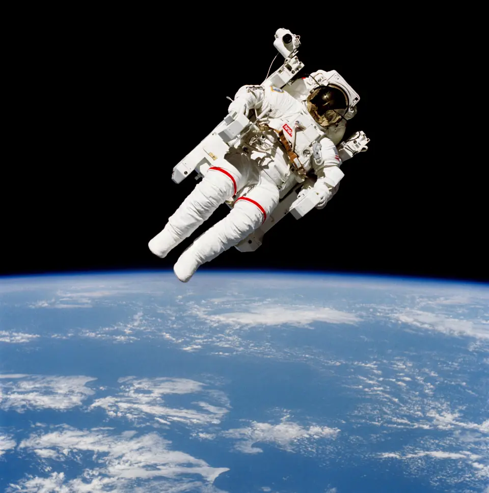 Bruce McCandless floating utterly alone in black space above the blue Earth, in a white suit with a jetpack, no tether.