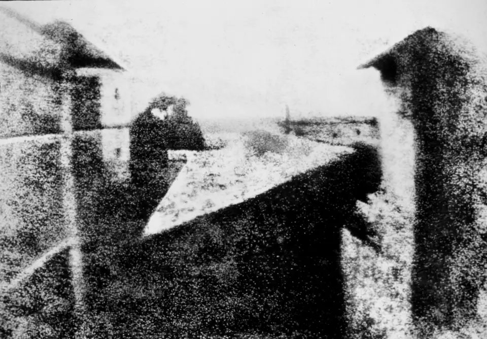 View from the Window at Le Gras, the first photograph: ghostly pale rooftops and a courtyard rendered in smeared gray tones on a pewter plate.
