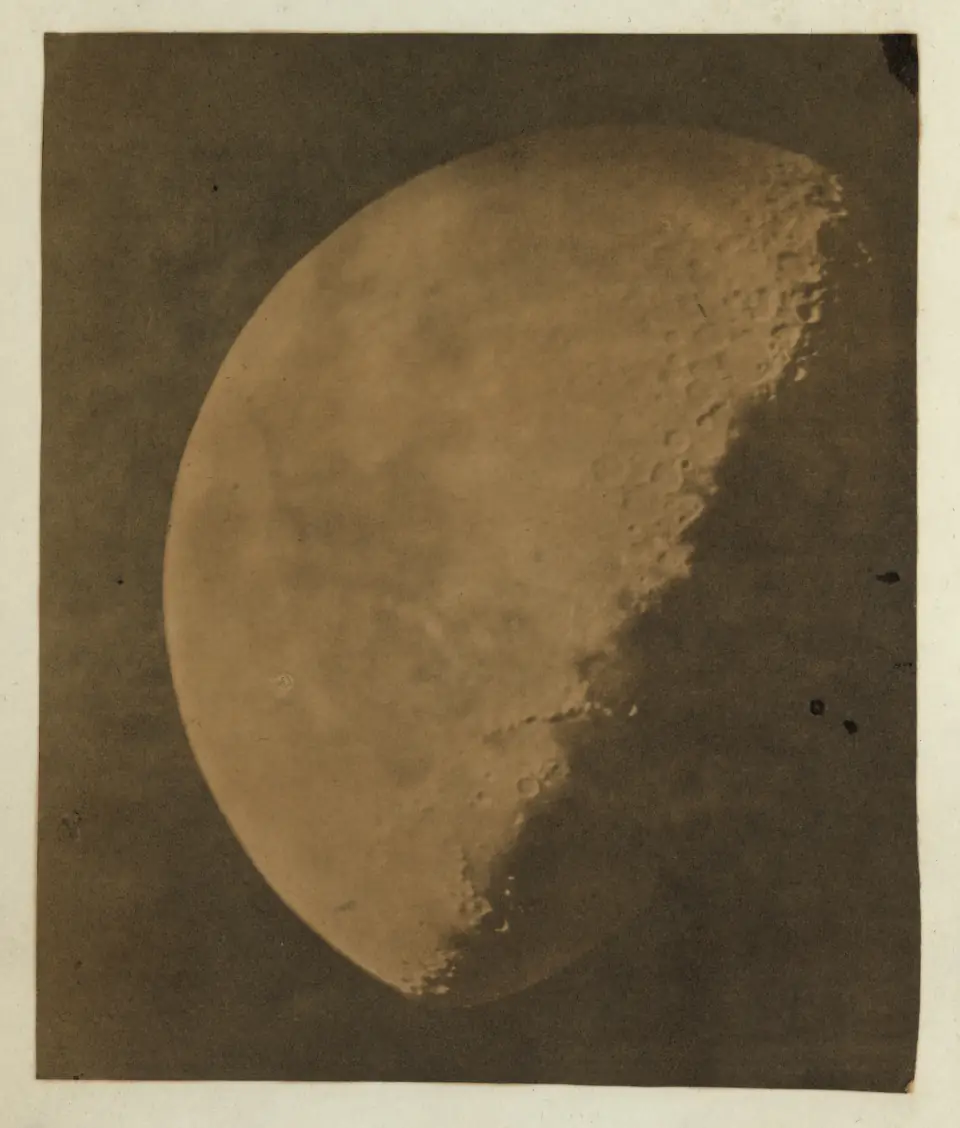 An 1851 daguerreotype of the Moon: a luminous gibbous moon floating in black, craters and seas faintly visible.