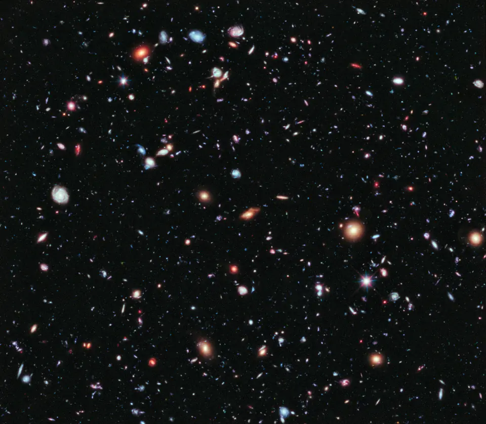 The Hubble eXtreme Deep Field: thousands of galaxies of every color and shape scattered across blackness.