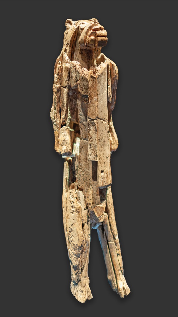 The Lion-man of Hohlenstein-Stadel: a slender standing figurine with a human body and a lion's head, carved from pale mammoth ivory.