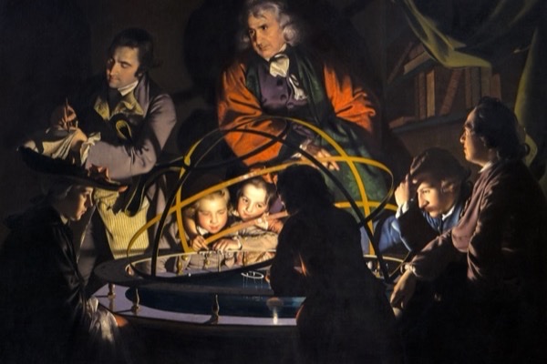 Joseph Wright of Derby's candlelit painting of figures gathered in the dark around a glowing brass orrery, a model of the solar system, with two children's faces lit by the lamp at its center.