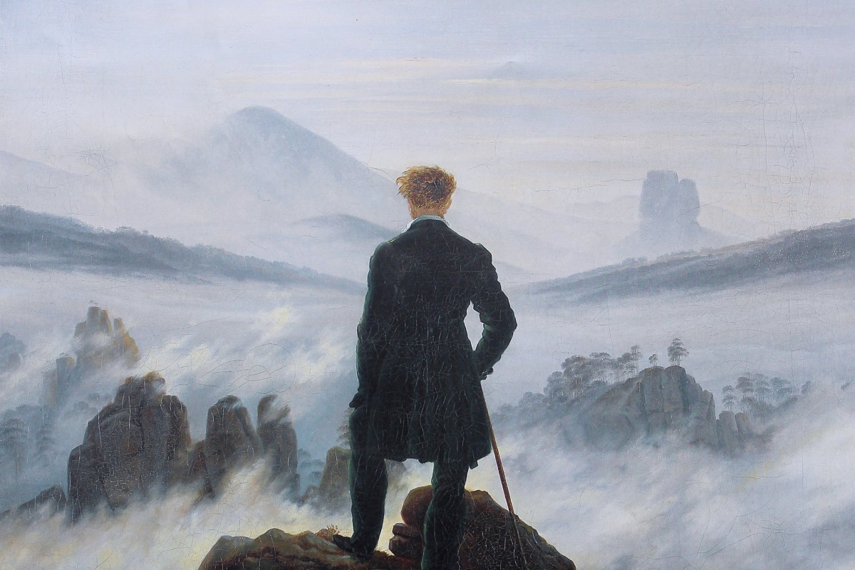 Caspar David Friedrich's painting Wanderer above the Sea of Fog: a man in a dark coat stands on a rocky summit, his back to us, looking out over peaks rising through a sea of mist.