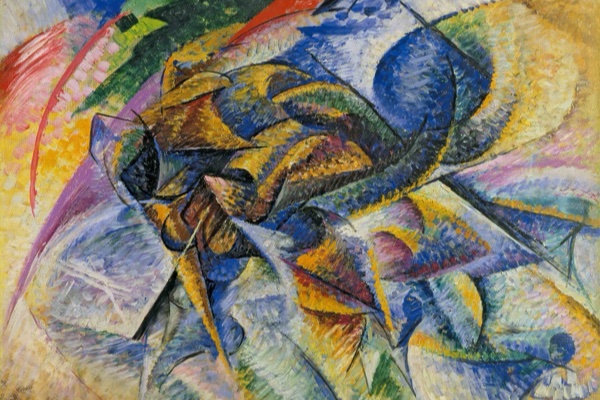 A Futurist oil painting: a cyclist dissolved into swirling planes of blue, gold and red, motion rendered as overlapping abstract shapes. Umberto Boccioni, Dynamism of a Cyclist (1913).