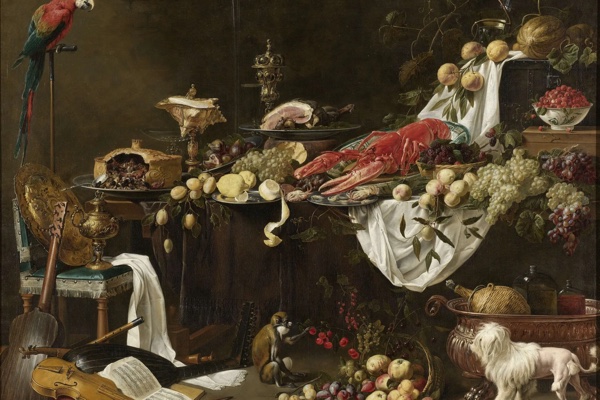 A lavish 17th-century Flemish banquet still life: a table piled with a lobster, fruit, bread, wine, and gleaming silver against a dark ground.